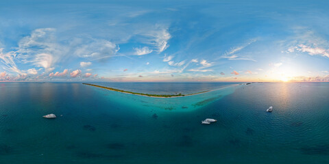 Luxury yacht next to one of the atolls of the Maldives. Aerial seamless spherical 360 degree panorama