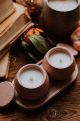 handmade scented candles, coffee, books and tangerines for the New Year. Cozy atmosphere of Christmas at home