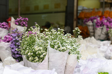 Bouquets of blooming flowers in shop