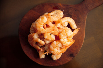 Boiled and peeled shrimp, ready to eat or used as an ingredient in salads, cocktails, toasts and many more recipes. Table top view.