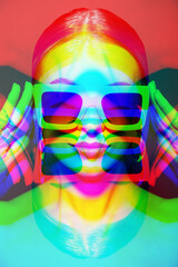 Close-up beautiful woman portrait with classic hairstyle, big retro sunglasses holding hands near head. RGB channel color split effect applied. Futuristic looking style