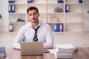 Fototapeta premium Young male employee working in the office