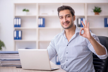 Young male employee working in the office