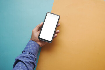  top view of young man hand using smart phone with white screen 