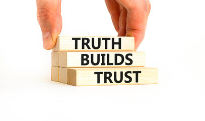 Truth builds trust symbol. Concept words Truth builds trust on wooden blocks on a beautiful white table white background. Businessman hand. Business truth builds trust concept. Copy space.