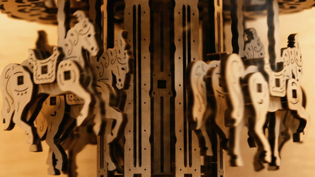 Artisan toy carousel in motion. Miniature horses in movement in vintage artisanal object