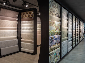 Wallpapers is in a shop. Great choice in row. Wallpaper для home. Rolls of vinyl wallpaper.