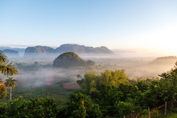 Morning fog over the Valley of Viñales with its big mogotes mountains, an Unesco World Heritage Site in Cuba, Caribbean