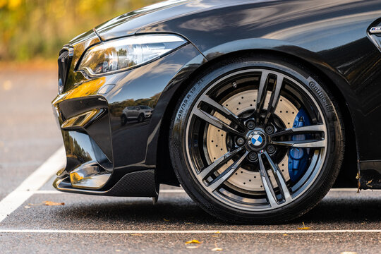Gothenburg, Sweden - October 16 2022: Front left wheel of a black BMW M2 sports car.