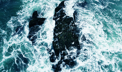 Aerial view of the ocean water surface and waves. Beautiful water background texture for tourism and advertising. Tropical coast