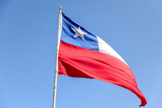 Valparaiso, Chile - January 2, 2023: The Chilean flag against a blue sky in the wine region outside of Valparaiso, Chile