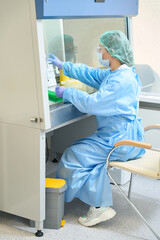 Scientist working in laboratory while holding special pipette