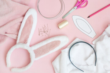flat lay. element of festive costume is hair band of ears of bunny made of faux fur. Supplies...