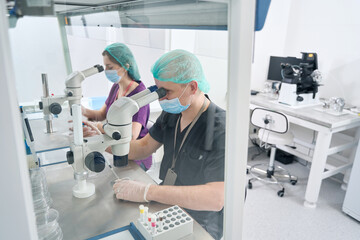 Man and a woman work in a modern laboratory