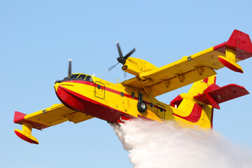 Athens, Greece - September 22, 2019: A firefighting aircraft releases the load of water as it tries.