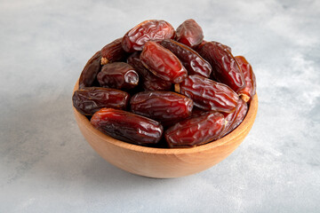Date fruits in wooden bowl,closeup