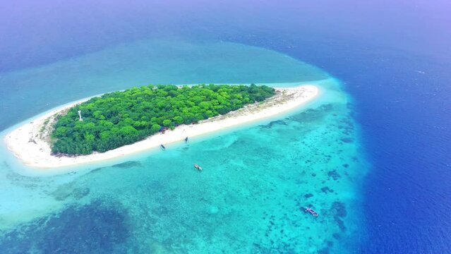 The small island named Tabuhan in the beautiful clear waters of the Bali Straits. Banyuwangi. Indonesia. Aerial footage taken with Drone.