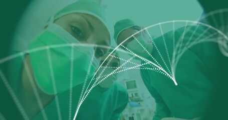 Animation of particles forming a dna structure over team of surgeons at operation theatre - Powered by Adobe