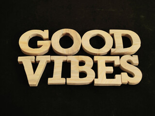 Good vibes, text words typography written with wooden letter, life and business motivational inspirational