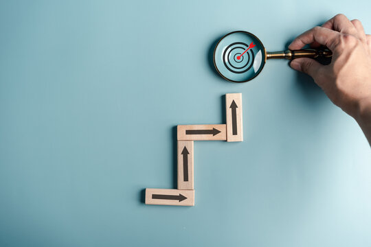 Business growth success achievement concept, hand arranging wooden block stacking as step stair or ladder or planning development leadership and customer target group