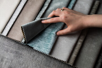 The designer chooses the fabric for the interior. 
Samples of fabrics of different quality and category for furniture upholstery or curtains.