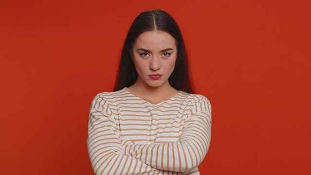 Angry aggressive pretty woman showing fig negative gesture, you dont get it anyway. Rapacious, avaricious, acquisitive. Body language. Refusal fig sign. Greedy avaricious girl on red background