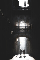 Women walkin in an early morning below Pont del Bisbe bridge in downtown Barcelona, Spain - 575173843