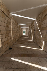Interesting pattern of lights shining in a long dark corridor