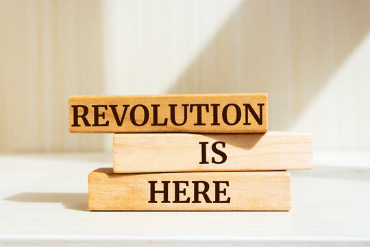 Wooden blocks with words 'Revolution is Here'.