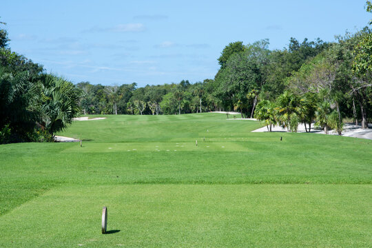 A panoramic view of a deserted golf course on a sunny morning in Mexico