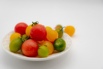 Fototapeta na wymiar a dish of fresh cherry tomato on white background