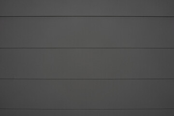 Clear background of a black gray wall with horizontal lines.