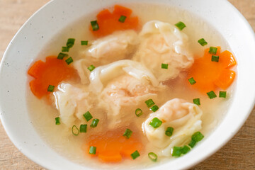 shrimp dumpling soup in white bowl