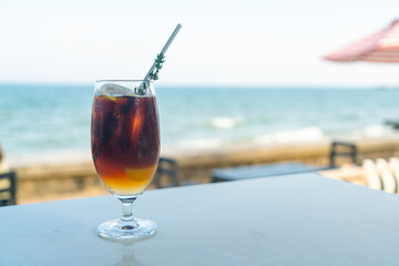 iced americano coffee peach with sea background