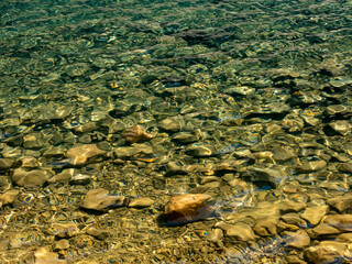 small rocks in shallow water of Lake Louise in Canada