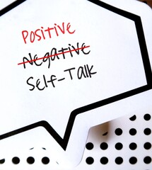 Note sticker  with text written NEGATIVE SELF-TALK changed to POSITIVE , concept of overcome...