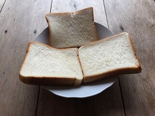 Bread on wooden background. Rustic rye. Fresh loaf of rustic traditional bread on wooden texture background. Bakery with crusty loaves. Design element for bakery product label, design, and etc