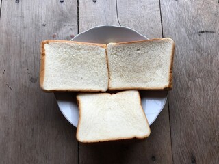 Bread on wooden background. Rustic rye. Fresh loaf of rustic traditional bread on wooden texture background. Bakery with crusty loaves. Design element for bakery product label, design, and etc