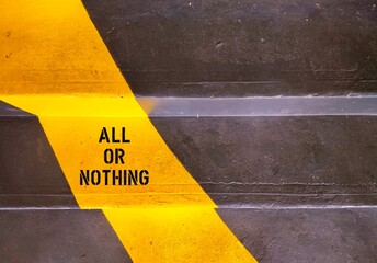 Painted yellow color on stairs with text written ALL OR NOTHING means doing something either...