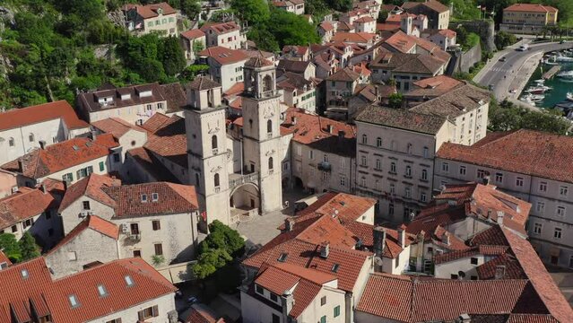 Kotor Old town in summer sunny day from drone. Aerial view Twin Towers Of St Tryphon Church in Kotor. 