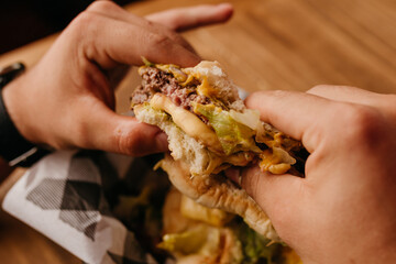 Burger - Man with watch on his wrist holding a hamburger in his hands