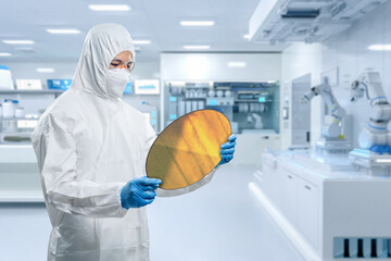 Worker or engineer wears medical protective suit or white coverall suit with silicon wafer