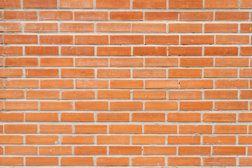 Red brick wall background in rural room. Abstract weathered texture stained old stucco light Red. Red grunge brick wall background.