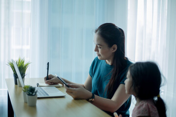 Woman and girl with computer laptop.