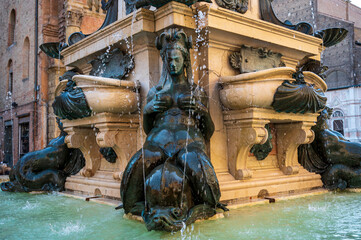 Fototapeta na wymiar Black statue of a woman at the Neptune fountain in Bologna