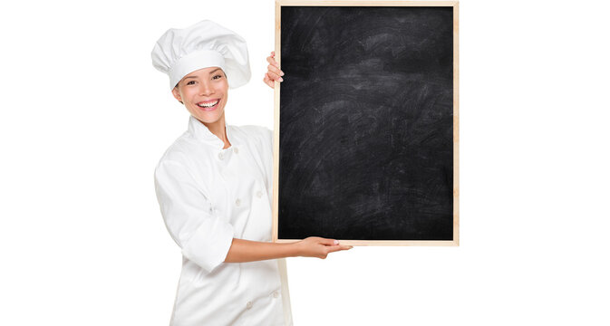 Chef. Woman cook showing empty menu chalkboard with copy space. Smiling Asian Caucasian female chef isolated cutout PNG on transparent background holding nice textured blackboard for advertising.