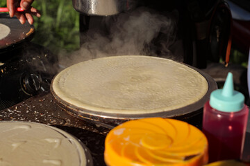 process of cooking pancake crepes at street food center