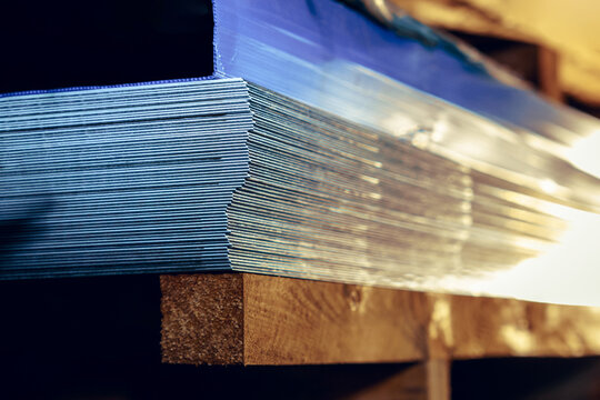 Sheets of metal in a stack in a warehouse