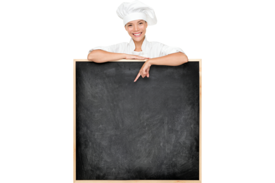 Chef showing menu sign blackboard happy. Empty menu chalkboard with copy space for text. Chef, baker or cook isolated cutout PNG on transparent background. Mixed race Asian Caucasian female model.