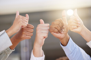 Hands, thumbs up and motivation with a business team in celebration of a goal, target or deal at...